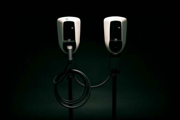 a couple of black and white phones on a black background